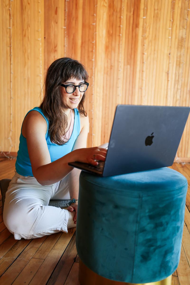 Cait smiling at her laptop during a virtual session